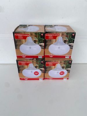three boxes of air freshener sitting on top of a white table