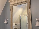 a bathroom with a sink and a mirror on the wall