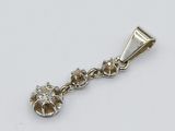 an image of a diamond pendant on a chain on a white surface
