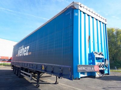 a blue trailer that is parked in a parking lot