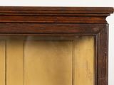 a clock that is sitting on top of a wooden shelf