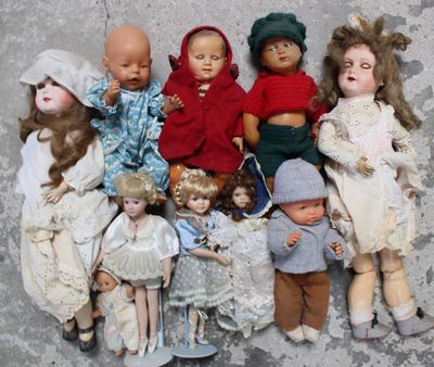 a lot of dolls that are sitting together on the floor