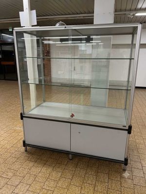 a glass display case in the middle of a room