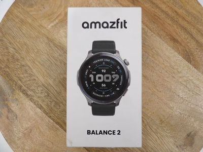 an image of a smart watch sitting on top of a wooden table