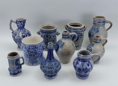 many blue and white vases sitting on a white surface