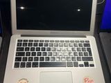 a laptop computer sitting on a desk with a sticker on it