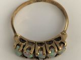 a close up of a gold ring with oplites on it