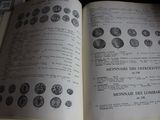 an open book that has a bunch of coins on it