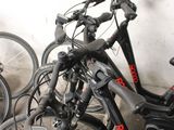 many bikes that are lined up against a wall