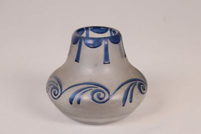 un vase bleu et blanc posé sur une surface blanche