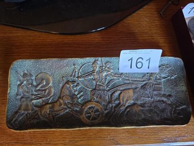 a metal plaque with a horse drawn carriage on it