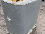 an image of an old refrigerator in a parking lot