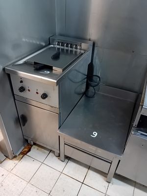 a stove and oven in a kitchen with a tile floor
