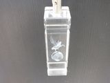 a clear glass vase with a silver bird on it