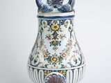 a blue and white vase sitting on a white surface
