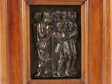 a close up of a metal plaque in a wooden frame