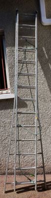 a ladder leaning up against a building next to a window