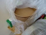 a stack of plates in a plastic bag on the floor