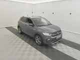 a grey volkswagen suv parked in a garage with a checkered floor