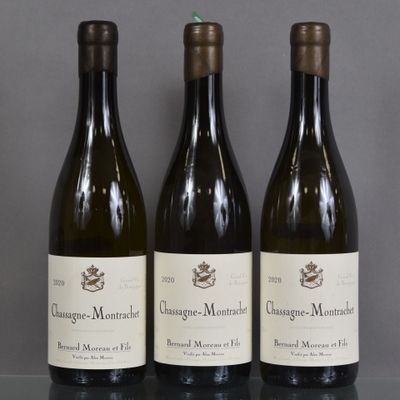 three bottles of wine sitting on a table next to each other