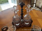 two glass vases sitting on a table next to a candle