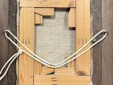 a picture of a wooden frame with a rope around it