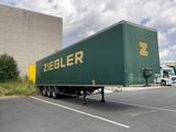 a large green truck that is parked in a parking lot