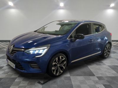 a blue car parked in a garage with a checkered floor