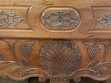 a wooden dresser with a carved design on it