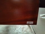 a close up of a wooden table with a label on it