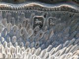 a close up of a silver plate with writing on it
