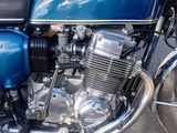 a blue motorcycle parked on the side of the road