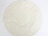 a pizza dough that is on a white surface