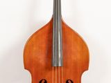 a close up of a cello on a stand on a wooden floor