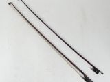 a pair of metal wires on a white surface