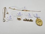 some gold and silver jewelry including a necklace, earrings, and a broocher