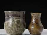 two vases sitting next to each other on a table