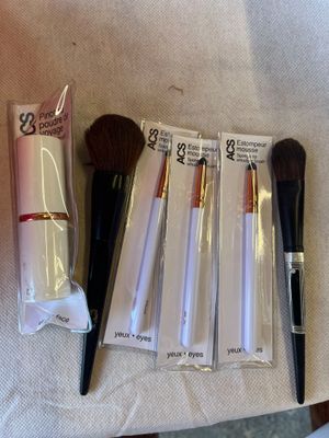 tout un tas de pinceaux de maquillage posés sur une table