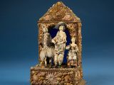 carved ivory figurine of a group of people and a dog