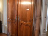 a large wooden cabinet in the middle of a living room