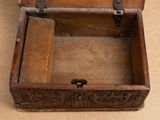 a small wooden box with a handle on the floor