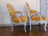 two chairs sitting next to each other on a wooden floor