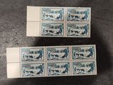 a couple of stamps sitting on top of a table next to each other