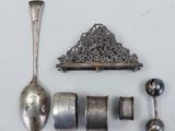 a spoon, spoon rest, and other silverware on a table