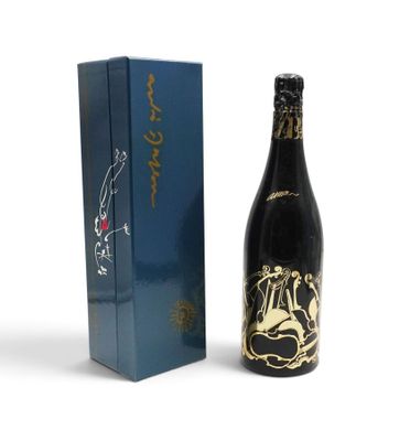 the bottle of wine is next to the box on the table
