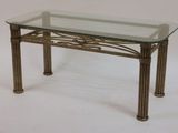 a glass table with metal legs and a glass top