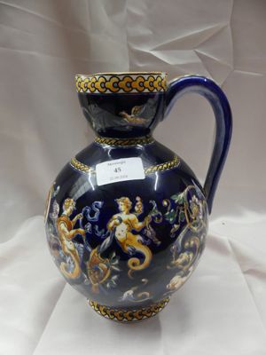 un vase bleu et or posé sur un linge blanc