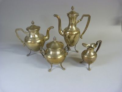 five pieces of silver on a white surface