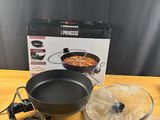 a close up of a frying pan on a wooden table