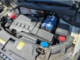 the engine of a car with a bunch of batteries in it